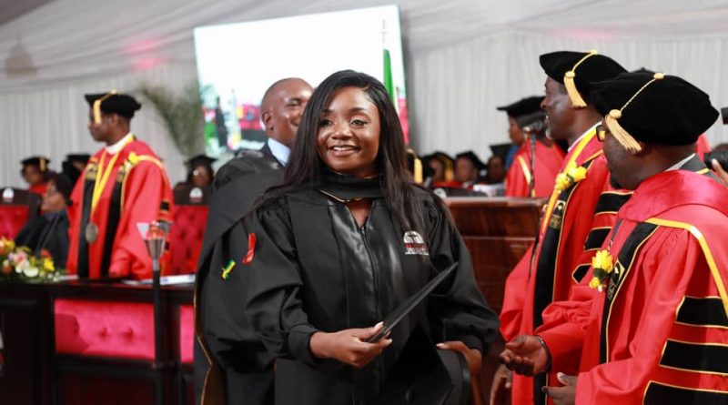 Graduate smiling during a university ceremony