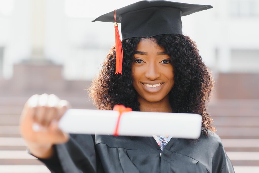 Graduate holding her diploma