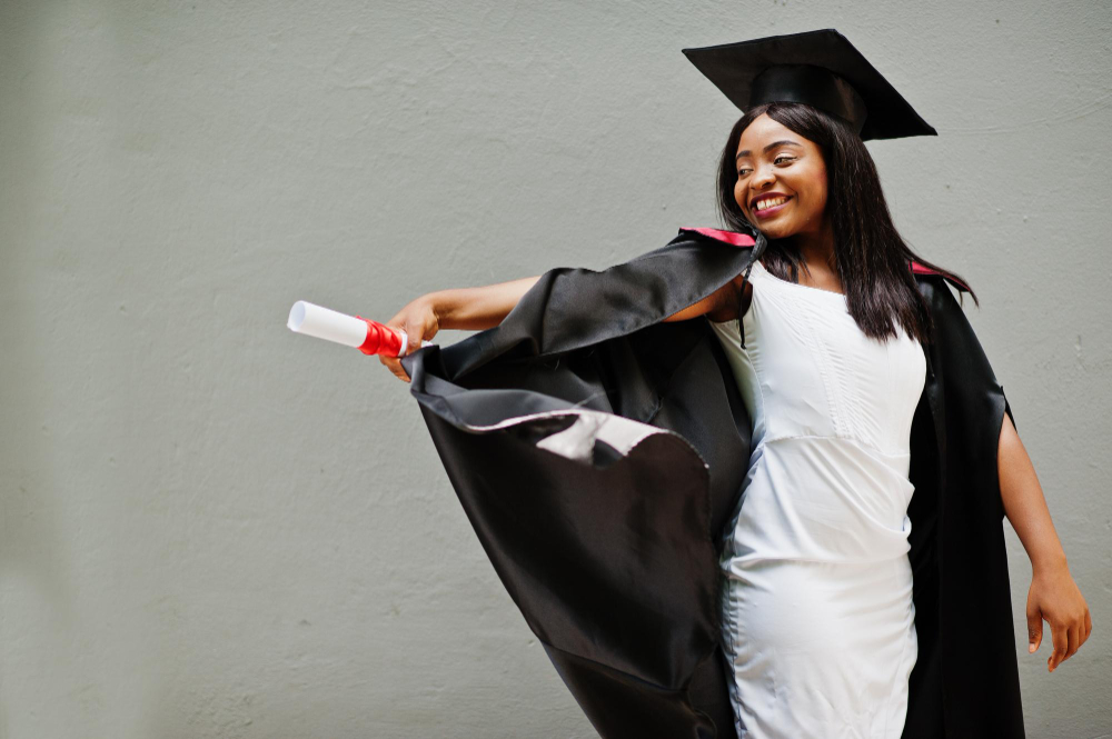 Graduate posing in cap and gown