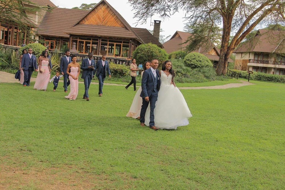 Wedding party crossing a garden