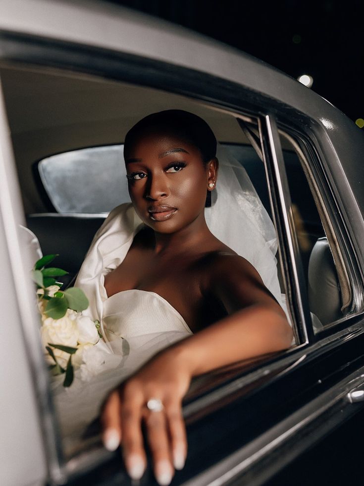 Bride seated inside her wedding car