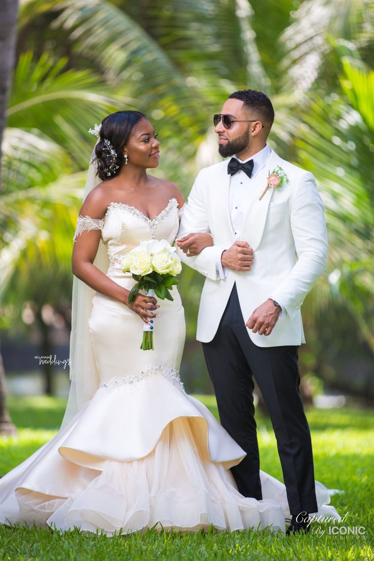 Newlyweds holding a white bouquet