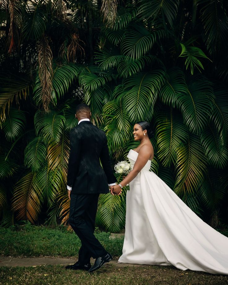 Couple walking beneath palms