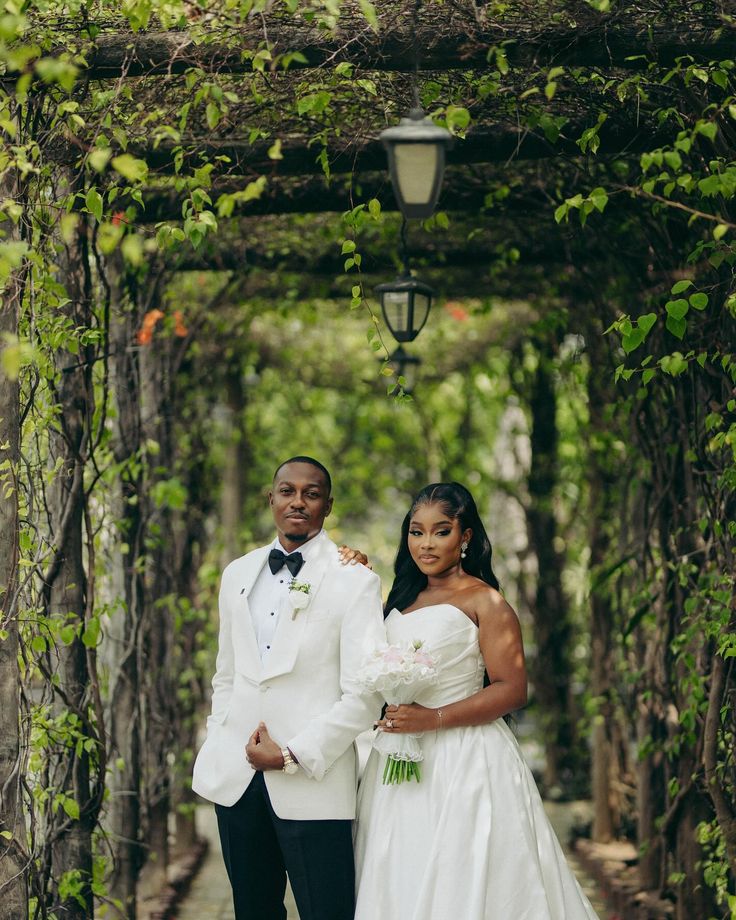 Newlyweds beneath a garden arch
