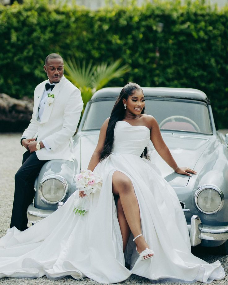Newlyweds beside a vintage car